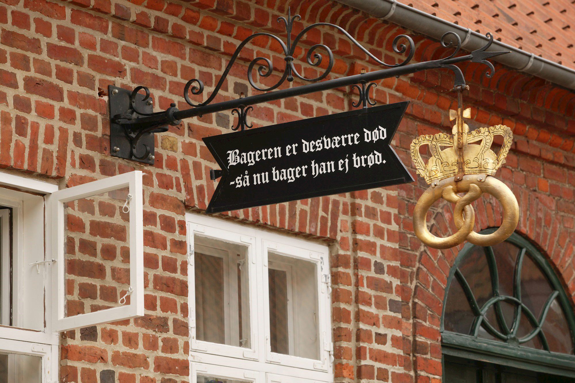 Skilt i Sct. Mogens Gade i Viborg med teksten "Bageren er desværre død - så nu bager han ej brød"